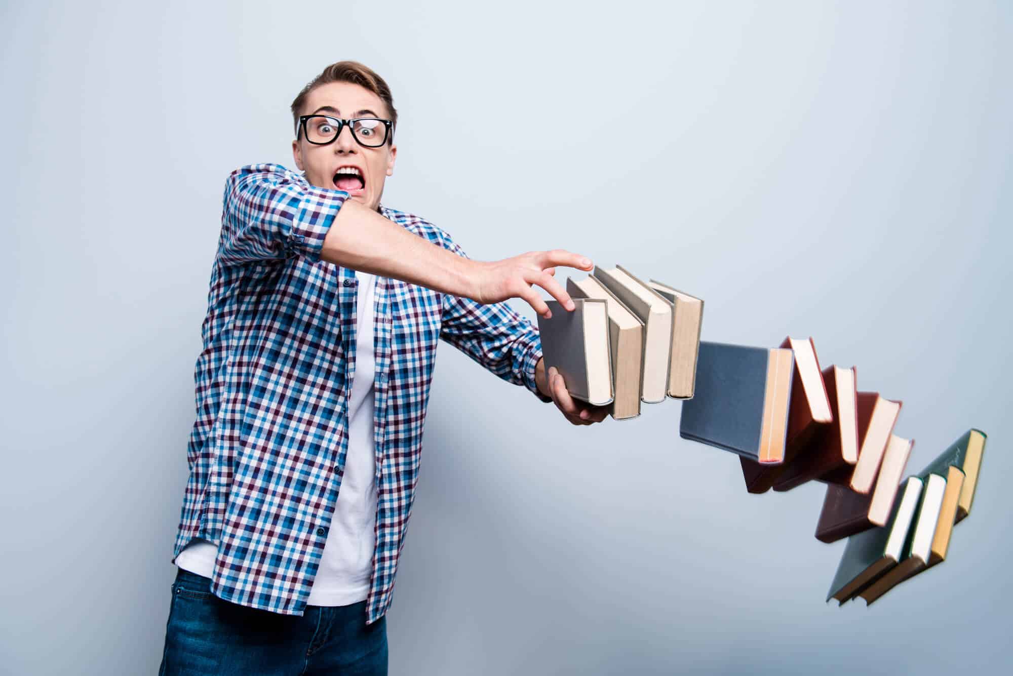 teen boy dropping books